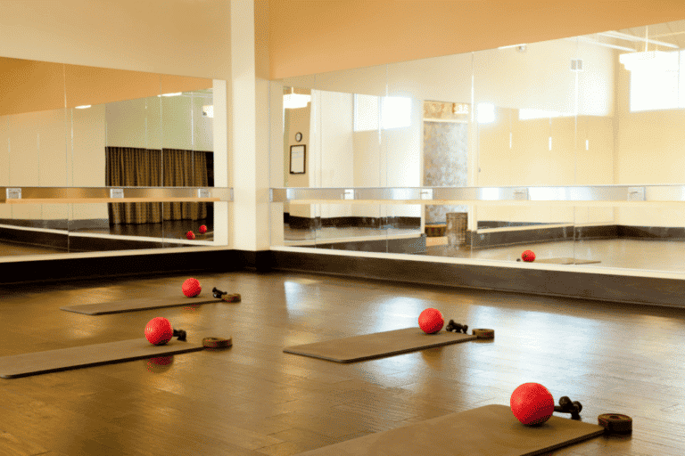 A gym prepared for a yoga class with mats and props, thanks to commercial janitorial services