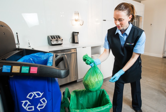 Green Cleaning - GDI Employee Engaged in Waste Sorting for Environmentally Friendly Practices